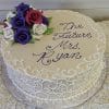 The BR-023 is a round cake with white icing swirls, purple, red, and white fondant roses on top, and “The Future Mrs. Ryan” written in purple script.