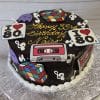 BD-063 Ganache with 80’s theme/music notes: A chocolate cake topped with Rubik’s cubes, cassette tapes, I Love 80s signs, purple Pac-Man ghosts, and music notes. Yellow writing on top reads “Happy 33rd Birthday Naiso.”.