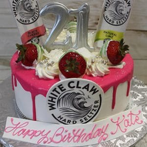 The BD-024Q WhiteClaw cake features pink and white icing, strawberries, two White Claw cans, a silver 21 topper, and a "Happy Birthday Kate" message in pink on a white plaque.