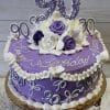The BD-041 is a round purple cake with white and purple roses, elegant white icing details, a large “90” topper, and “Happy Birthday” in white script—perfect for celebrating a 90th birthday.