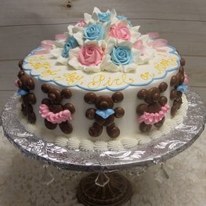 The BB-012 is a round cake featuring chocolate teddy bears, pink and blue bows, pink and blue icing roses, and the words "Girl or Boy?" written in yellow icing.