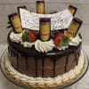 A BD-024L Kahlua chocolate drip cake topped with whipped cream, strawberries, mini Kahlua bottles, and a white chocolate plaque with cursive writing, presented on a glass cake stand.