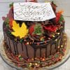 The THX-013 is a chocolate birthday cake topped with strawberries, autumn leaf-shaped decorations, sprinkles, and a white plaque reading "Happy Birthday Lisa" in cursive. The cake is displayed on a glass stand.