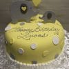 BB-041: A round yellow cake with white and gray polka dots, topped with two elephant decorations holding a yellow balloon and "Happy Birthday Lucas" written in cursive icing.