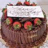 The BD-014A Chocolate/Chocolate is a round chocolate cake garnished with chocolate-dipped strawberries, chocolate shavings, and a white “Happy Birthday” card, presented on a gold cake board.