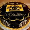 The ST-006 Bruins Ganache is a round cake with a glossy black finish, the Boston Bruins logo on top and sides, yellow piping, and “Happy Birthday Khristian” written in yellow icing.