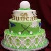 The TC-146 is a three-tiered golf-themed cake for a 50th birthday, decorated with golf balls, clubs, flags, and a large golf ball on top. "50 Duncan" is written in gold letters on the cake.