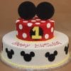 The TC-147 is a two-tier birthday cake: the top layer has red and white polka dots, a yellow number 1, and black mouse ears; the white bottom layer features black mouse head silhouettes and "Happy Birthday!" in red.