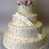 The WD-100 is a three-tiered white wedding cake with cream-colored swirls, pink and white roses on top, and a white ribbon featuring "Kelly and Daniel.