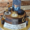 The BD-071B is a round Jack Daniel’s-themed cake featuring mini whisky bottles, gold horseshoes, a clock face, flat cap, man’s portrait, and a plaque that says “Happy 40th Fookin Birthday Kevin.”.
