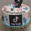 CB-032 is a round white cake with colorful music notes, a large number 9 topper, blue icing border, TikTok logo on the side, and @shirahslayz written on top.
