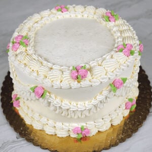 Fancy piping with buttercream frosting and small buttercream pink roses. Order this cake for any occasion, include your custom inscription.