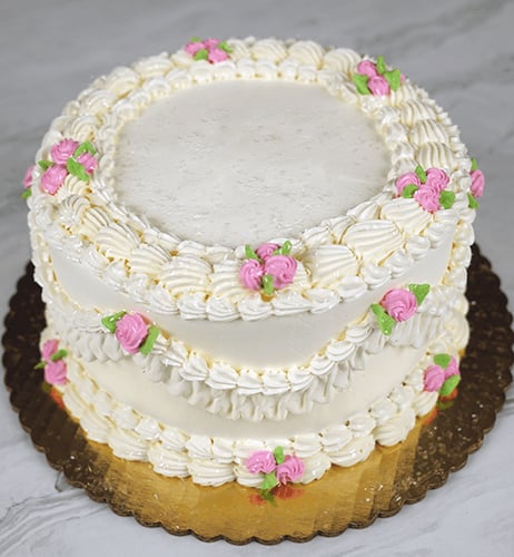 Fancy piping with buttercream frosting and small buttercream pink roses. Order this cake for any occasion, include your custom inscription.