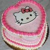 Pink heart-shaped cake decorated with a Hello Kitty design and piped frosting details