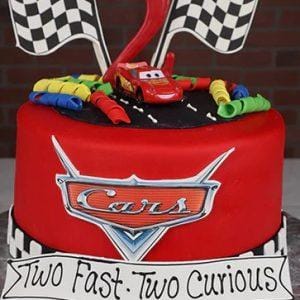 Cars-themed birthday cake with decorations