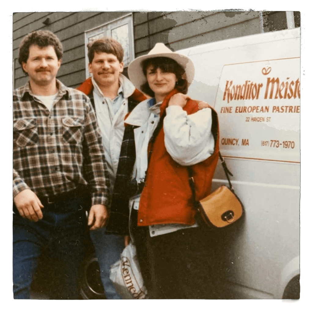 Historic photo of Konditor Meister team members standing beside a branded delivery van