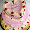WD-105 is a two-tier heart-shaped wedding cake decorated in soft pink and white, with bright red cherries and delicate red accents. “Just Married” is written in gold on top for a playful, romantic touch.